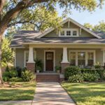 Well-maintained Craftsman bungalow with a covered porch and shingled roof, illustrating older home insurance.
