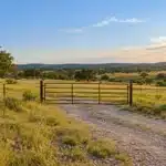 Vacant land insurance in Texas for an undeveloped parcel with a gated entrance