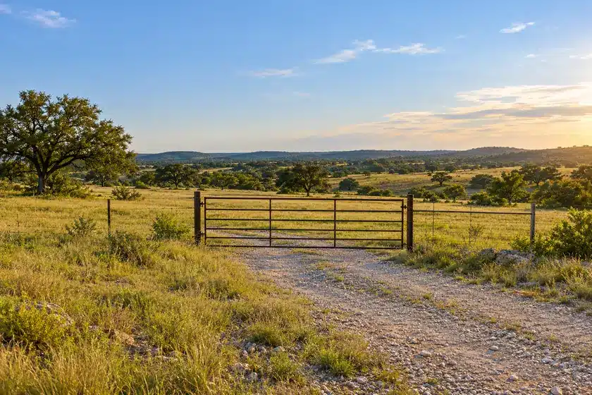 Vacant land insurance in Texas for an undeveloped parcel with a gated entrance